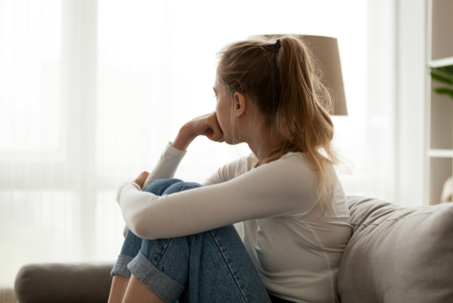 Side view of young woman deep in thought