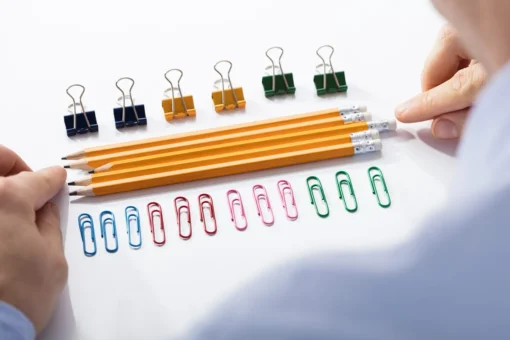 Arranging pencil between office supplies
