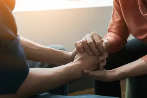 Two people holding hands.