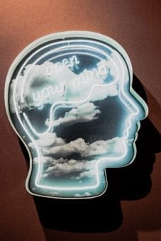 image of a light in the shape of a human head with "open your mind" written inside with cloud images