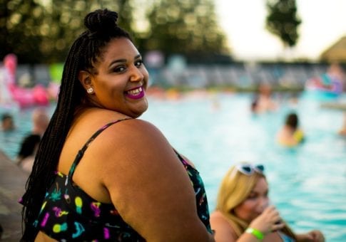 Woman smiling at the pool.