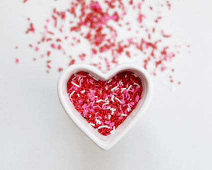 heart-shaped dish with red, pink, and white sprinkles