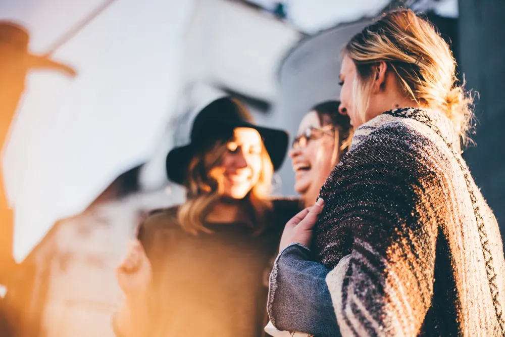 Group of female friends laughing.