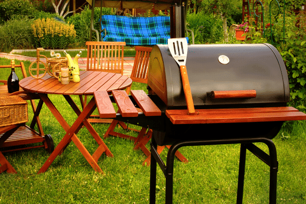 Backyard with grill and patio furniture.