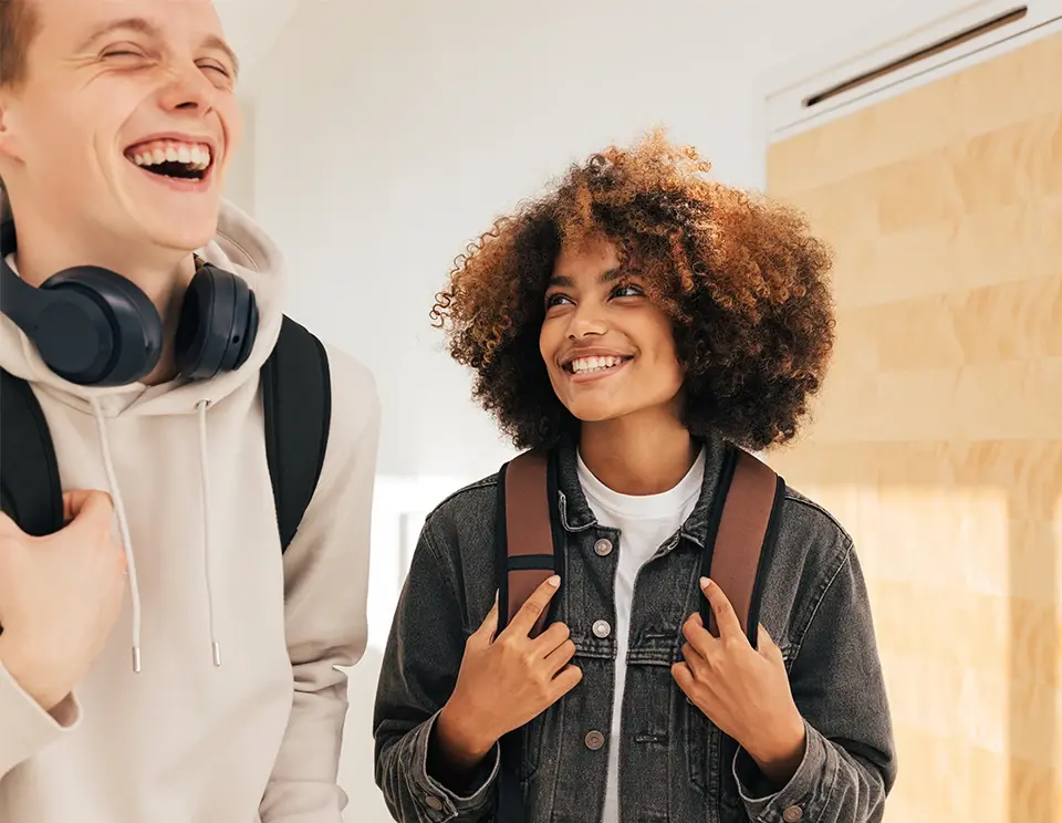 Two teenaged boys laughing.